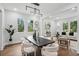 Elegant dining room featuring modern light fixture, sleek table, and views to the outside at 1604 Niskey Lake Sw Rd, Atlanta, GA 30331