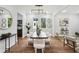 Elegant dining room featuring a black dining table, contemporary decor, and beautiful hardwood floors at 1604 Niskey Lake Sw Rd, Atlanta, GA 30331