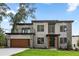 Beautiful modern home featuring a seamless two-car garage, balcony and stone accents, nestled in a lush green setting at 1604 Niskey Lake Sw Rd, Atlanta, GA 30331