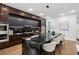 Stylish kitchen boasts an oversized island, modern appliances, sleek black cabinets, and hardwood floors at 1604 Niskey Lake Sw Rd, Atlanta, GA 30331