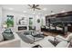 Open-concept living room with fireplace, modern decor, and views of the kitchen and backyard at 1604 Niskey Lake Sw Rd, Atlanta, GA 30331