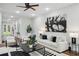 Bright living room with modern decor, a large painting, and a view of the staircase at 1604 Niskey Lake Sw Rd, Atlanta, GA 30331