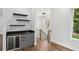 Contemporary living area featuring a sleek bar with a wine cooler, floating shelves, and hardwood floors at 1604 Niskey Lake Sw Rd, Atlanta, GA 30331