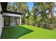 Artificial turf outdoor deck provides generous space and scenic views surrounded by lush greenery at 1604 Niskey Lake Sw Rd, Atlanta, GA 30331