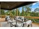 Covered outdoor patio with comfortable seating area surrounded by lush greenery and natural light at 1604 Niskey Lake Sw Rd, Atlanta, GA 30331