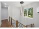 Modern staircase with wood treads, black metal railings, and a contemporary light fixture at 1604 Niskey Lake Sw Rd, Atlanta, GA 30331