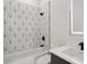 Modern bathroom showcases bold tilework, matte fixtures, and combined shower and tub at 1610 Niskey Lake Sw Rd, Atlanta, GA 30331