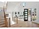 Bright foyer with soaring ceilings, showcasing a staircase and view to the living room with oversized windows at 1610 Niskey Lake Sw Rd, Atlanta, GA 30331