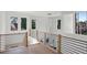 Hallway with hardwood floors, modern chandelier, and large windows overlooking trees at 1610 Niskey Lake Sw Rd, Atlanta, GA 30331