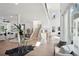 Bright open-concept living area with hardwood floors, a modern staircase, and a large picture window at 1610 Niskey Lake Sw Rd, Atlanta, GA 30331