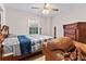 Cozy bedroom features a bed with ceiling fan and window view at 3189 Bellgreen Way, Decatur, GA 30032