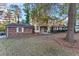 Charming two-story home featuring a brick exterior, front porch, and a spacious front yard with mature trees at 3189 Bellgreen Way, Decatur, GA 30032