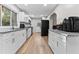 Modern kitchen features white cabinets, granite counters, and stainless appliances at 3189 Bellgreen Way, Decatur, GA 30032