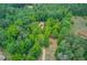 Aerial image showcasing property's wooded acreage with private driveway leading to home at 322 Kibbee Rd, Mcdonough, GA 30252