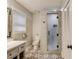 Stylishly updated bathroom boasts patterned tile floor and glass-enclosed shower at 322 Kibbee Rd, Mcdonough, GA 30252