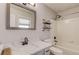 Updated bathroom features modern sink, bathtub with shower, and unique shelving at 322 Kibbee Rd, Mcdonough, GA 30252