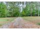 Picture of the driveway of the home running through a beautiful wooded area at 322 Kibbee Rd, Mcdonough, GA 30252