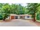 Charming ranch-style home with a two-car garage, mature trees, and a spacious driveway at 322 Kibbee Rd, Mcdonough, GA 30252