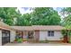 Inviting front of home with rocking chairs and a brick accent wall at 322 Kibbee Rd, Mcdonough, GA 30252