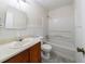 Standard bathroom featuring a tub and shower combination with a tiled floor, sink, and lighting at 5255 Biffle Downs Rd, Stone Mountain, GA 30088