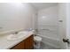 Modest bathroom featuring a standard white tub, toilet, and vanity with clean, neutral tones and tiled flooring at 5255 Biffle Downs Rd, Stone Mountain, GA 30088