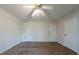Bedroom featuring two closets, neutral carpet, ceiling fan, and white walls at 5255 Biffle Downs Rd, Stone Mountain, GA 30088