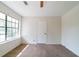 Cozy bedroom featuring a carpeted floor and large window, offering ample natural light, with view to greenery outside at 5255 Biffle Downs Rd, Stone Mountain, GA 30088
