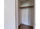 Empty closet with a simple shelf and rod setup, ready for organized storage in a compact space at 5255 Biffle Downs Rd, Stone Mountain, GA 30088