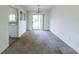 Open dining area with sliding glass doors to the backyard, connecting indoor and outdoor spaces and carpeted floors at 5255 Biffle Downs Rd, Stone Mountain, GA 30088