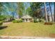 Charming single-story home featuring a cozy front porch and a well-maintained lawn with mature trees at 5255 Biffle Downs Rd, Stone Mountain, GA 30088