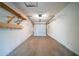 An attached one car garage with shelving and a garage door at 5255 Biffle Downs Rd, Stone Mountain, GA 30088