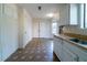 Kitchen featuring ample storage, a large window, with white cabinets and a contrasting floor at 5255 Biffle Downs Rd, Stone Mountain, GA 30088