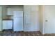 Kitchen with a refrigerator, cabinets, and countertop space, set on patterned flooring at 5255 Biffle Downs Rd, Stone Mountain, GA 30088
