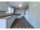 Functional kitchen with white appliances, ample counter space, and patterned flooring at 5255 Biffle Downs Rd, Stone Mountain, GA 30088