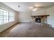 Cozy living room featuring a stone fireplace, a ceiling fan, and a large window at 5255 Biffle Downs Rd, Stone Mountain, GA 30088