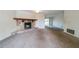 Open-plan living room with a stone fireplace, neutral carpet and access to the outdoors at 5255 Biffle Downs Rd, Stone Mountain, GA 30088