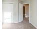 Bedroom showcasing neutral walls, carpet flooring, and closet with view to another room at 870 Chapman Cir, Stone Mountain, GA 30088