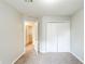 Standard bedroom with neutral walls, carpet, closet, and view to another room at 870 Chapman Cir, Stone Mountain, GA 30088