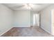 Spacious bedroom features neutral walls, carpet flooring, ceiling fan, and a view of the hall at 870 Chapman Cir, Stone Mountain, GA 30088