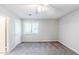 Well-lit bedroom with neutral walls, carpet flooring, ceiling fan, and window, plus a door at 870 Chapman Cir, Stone Mountain, GA 30088