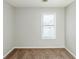 Cozy bedroom with neutral walls, carpet flooring, and a window offering natural light at 870 Chapman Cir, Stone Mountain, GA 30088
