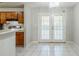 Bright dining area with tile flooring, double doors, and a chandelier at 870 Chapman Cir, Stone Mountain, GA 30088