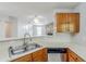 Efficient kitchen layout with white countertops, oak cabinets, and stainless steel sink at 870 Chapman Cir, Stone Mountain, GA 30088