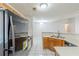 Traditional kitchen design featuring wood cabinets, white appliances, and neutral countertops, plus tile flooring at 870 Chapman Cir, Stone Mountain, GA 30088