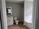 Clean bathroom featuring a vanity, toilet, shower, and tub combo, offering functionality and comfort at 1142 Windsor Sw St, Atlanta, GA 30310