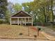 Charming home with a front porch, inviting curb appeal, and a spacious front yard with mature trees at 1142 Windsor Sw St, Atlanta, GA 30310