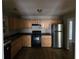 Functional kitchen featuring stainless steel appliances, wooden cabinets, and a clean, practical layout at 1142 Windsor Sw St, Atlanta, GA 30310