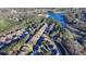 This aerial shows the home's location in a serene neighborhood, nestled amongst lush greenery and a lake at 2505 Weber Heights Way, Buford, GA 30519