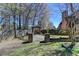 Grassy backyard with wood fence and an ornate stone patio with arbor at 2505 Weber Heights Way, Buford, GA 30519