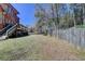 Fenced backyard featuring a grassy area, patio and landscaping, ideal for outdoor activities at 2505 Weber Heights Way, Buford, GA 30519